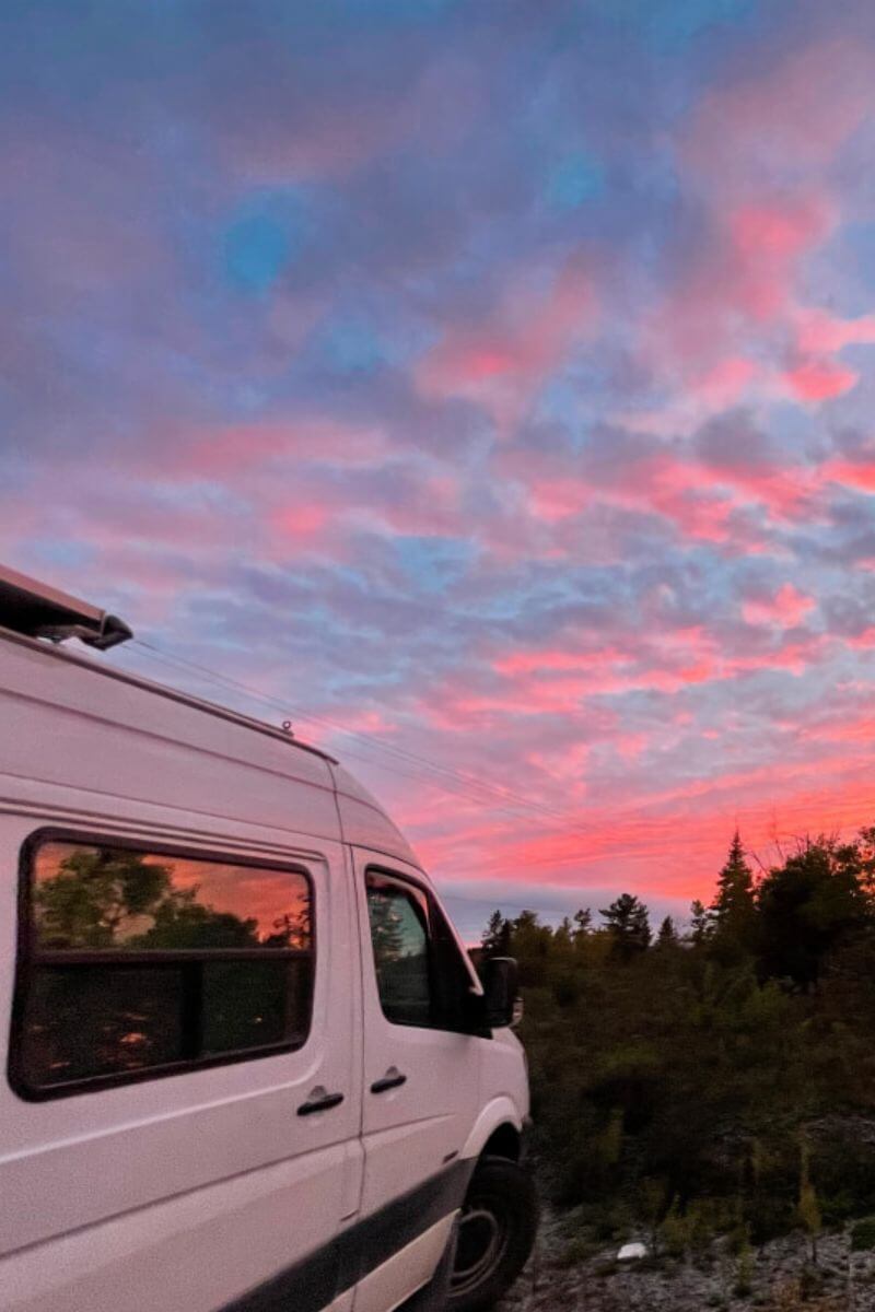 Lonavity van, custom van conversion pink, blue and purple skies reflecting on the van in Ontario